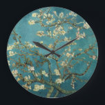 Reloj de pared de flores de almendra<br><div class="desc">Florecimiento de Almond por Vincent van Gogh La flor de almendras fue pintada en 1890 en honor a un evento especial en la vida de Vincent. El 31 de enero, el hermano de Vincent, Theo, y su esposa Johanna, tuvieron un hijo, y lo llamaron Vincent Willem. Vincent pintó esta rama...</div>