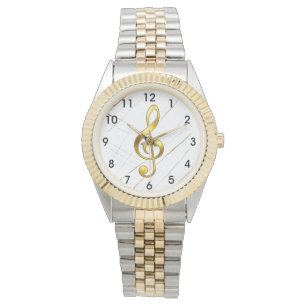 Reloj de pulsera con clave de sol de oro sobre már