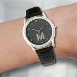 Reloj De Pulsera Monograma elegante de oro negro moderno<br><div class="desc">Reloj personalizado de Monograma en blanco y negro con números simples en blanco. Este reloj elegante y minimalista combina el estilo clásico con un toque personal, con una inicial audaz de color dorado (nota: el oro es un color plano sin ningún brillo) sobre una cara negra, acentuada por simples números...</div>