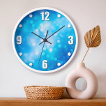 Reloj Paquetes abstractos sombríos de color azul turques<br><div class="desc">Sorprendentemente, los círculos de luz de efecto de bokeh redondeados salen del fondo abstracto azul turquesa brillante. Relájese en su habitación favorita con este impresionante y vibrante reloj de pared. Tu elección de una cara de reloj redonda o cuadrada. ¡Hace un gran regalo de bienvenida! Puede personalizar fácilmente este reloj...</div>
