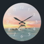Reloj Redondo Grande Dolphins Beach Sunset Ocean Seascape acuático<br><div class="desc">El arte de la pared de relojes de la playa presenta una pintura acuarela marina de un lacustre que salta a nadar al atardecer del océano. Perfecto para las casas de playa,  las temáticas náuticas,  costeras y tropicales. Obra de KL Stock.</div>