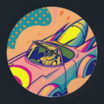 Reloj Redondo Grande Pop Art Astronaut Driving Rocket Car<br><div class="desc">This is a vibrant digital illustration in a pop art style featuring an astronaut driving a futuristic, rocket-powered car. The astronaut, wearing a yellow and white spacesuit with a green visor, is at the wheel of a pink and yellow car with large rocket boosters attached to the rear. Flames and...</div>
