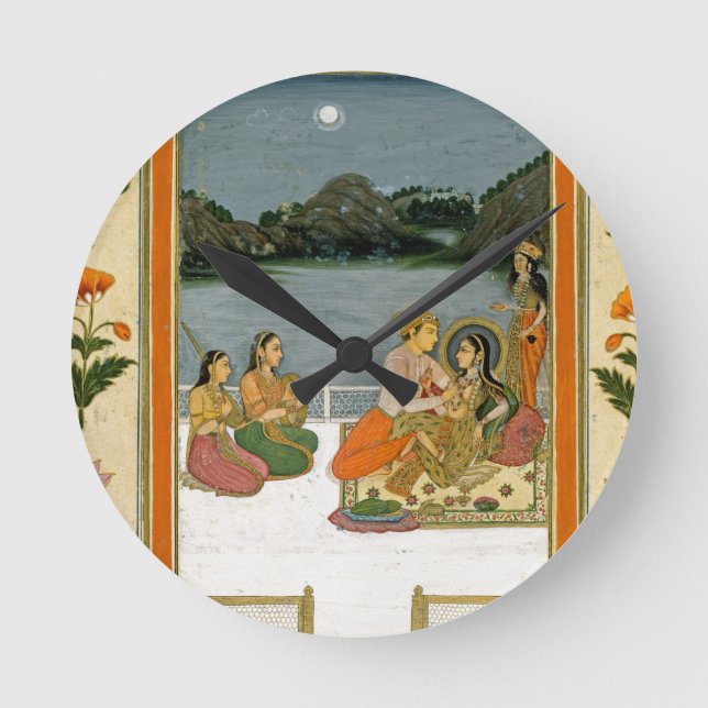 Reloj Redondo Mediano Amantes en una terraza por un lago iluminado por (Anverso)