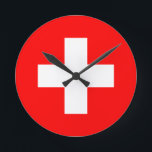 Reloj Redondo Mediano bandera de suiza<br><div class="desc">La bandera de Suiza (alemana: Schweizerfahne; francesa: drapeau de la Suisse; italiana: bandiera svizzera; románica: bandiera de la Svizra) muestra una cruz blanca en el centro de un campo cuadrado rojo. La cruz blanca es conocida como la cruz suiza.</div>