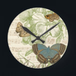Reloj Redondo Mediano Butterflies on Sheet Music with Floral Design<br><div class="desc">A green floral design and sheet music serves as the background to a trio of butterflies in this piece by Vision Studio. The French word for butterfly, papillon, is emblazoned at the bottom of the piece as well. If you have a strong love of butterflies, nature, or just like surrounding...</div>