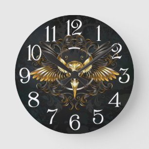 Reloj Redondo Mediano Cráneo de pájaro dorado sobre fondo negro