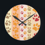 Reloj Redondo Mediano Paw Imprime adorables perros.<br><div class="desc">Diseño con un adorable patrón de pinturas de perro en colores naranja y amarillo y cálido. ¡Este diseño parece como si un perro hubiera pasado por encima del producto! Para los amantes del perro en todas partes.</div>