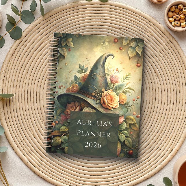 Rosa Gorra de Brujas - Planificador de Brujas de C (Rose Witch Hat – Cottagecore Witch Planner on a neutral boho table with eucalyptus, tea and seads.)