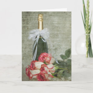 Rosas del aniversario y tarjeta de champán