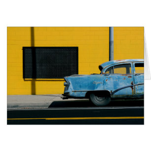 Rusty Blue Car and Yellow Wall