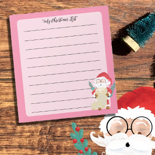 Santa Claus revisa su lista de Bloc de notas rosad