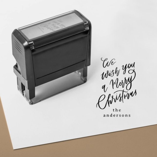 Sello Automático Te deseamos un regalo de Navidad feliz (self inking stamp with a hand lettering Merry Christmas message and custom family name)