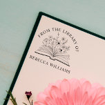 Sello Automático Tu nombre abre libro y flores desde la biblioteca<br><div class="desc">Añade un toque personal a tus libros con el sello de autoedición "Tu nombre abre libro y flores de la biblioteca de". Con un libro abierto bellamente ilustrado adornado con delicadas flores, este sello de personalizado que se autoinclina presenta elegantemente "Desde la biblioteca de" seguido de su nombre. Perfecto para...</div>