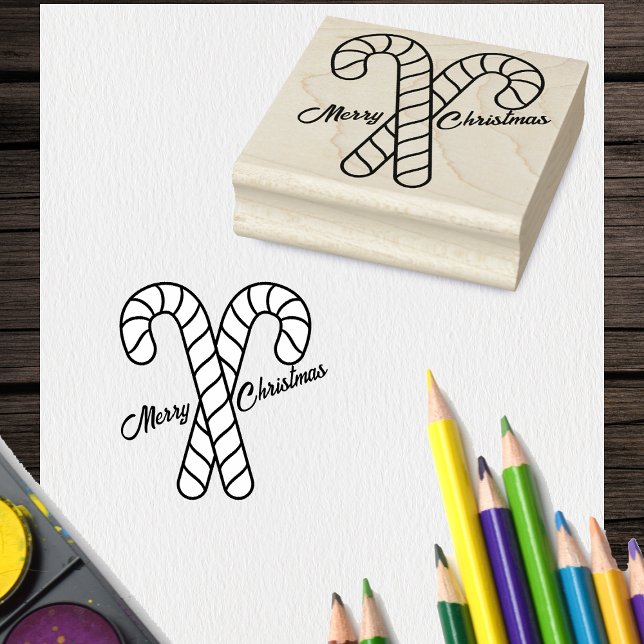 Sello De Caucho Dos aromas navideños cruzados de caña de candy (Two crossed striped candy canes with Merry Christmas on craft rubber holiday stamp.)