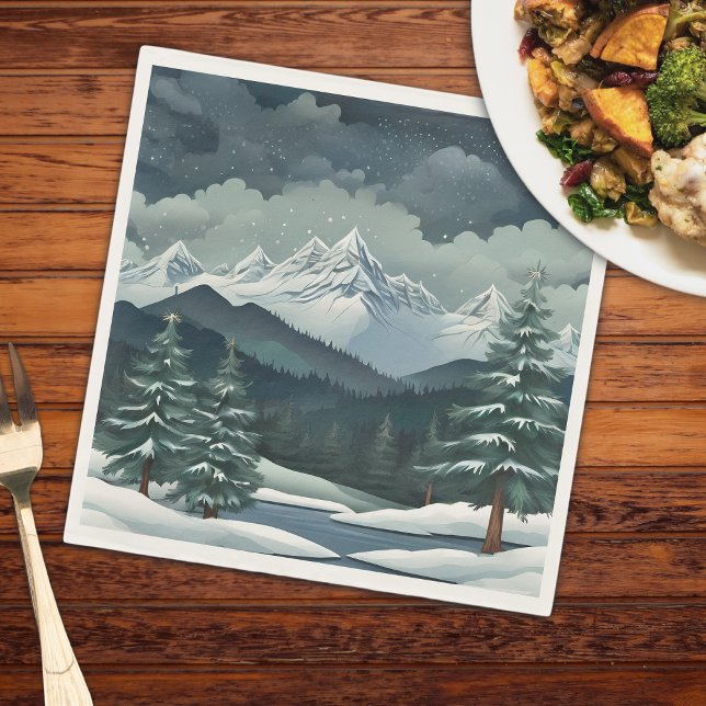 Servilleta De Papel Escena de la montaña de los bosques de invierno (A mountain scene on a napkin that is on a wooden table with a plate of food and a fork)