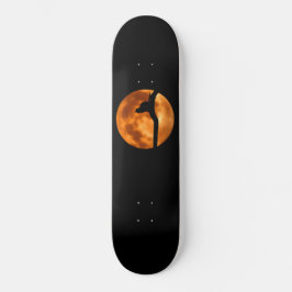 Silueta de un gato negro en un patineta de árbol