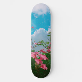 Skateboard Flores rosas bajo cielo azul con nubes - Naturalez