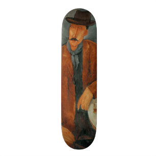 Skateboard Un hombre asentado que se inclina en una tabla