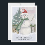Snowman en tarjeta de Navidades de árbol de pino d<br><div class="desc">La escena de cartas de los Navidades tradicionales incluye un muñeco de nieve de color agua con sombrero de Santa y bufanda verde. Pinos, leña y una valla de piquetes completan el escenario vacacional. Más abajo se escribe Feliz Navidad en un elegante tipo de letra en serif. Una segunda línea...</div>