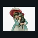 Sostener un gatito del navidad<br><div class="desc">El Victorian inspiró al chica que llevaba un capo rosado grande y que sostenía un gatito gris.</div>