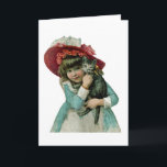 Sostener un gatito del navidad<br><div class="desc">El Victorian inspiró al chica que llevaba un capo rosado grande y que sostenía un gatito gris.</div>