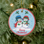 Sr. Y la Sra. Frosty El Ornamento De Cerámica Snow<br><div class="desc">Personalice este singular ornamento navideño "Uno de los dos"! Sr. Y la Sra. Frosty,  el hombre de nieve usando a sus Navidades Gorras,  acobardones y escarmenas de oído están dando un paseo mágico por un "Snowy Winter Wonderland"! Pintura original Bella Artes del artista Kerry Miller.</div>