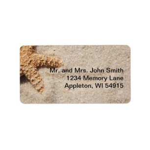 Starfish de bodas de playa en etiqueta de arena