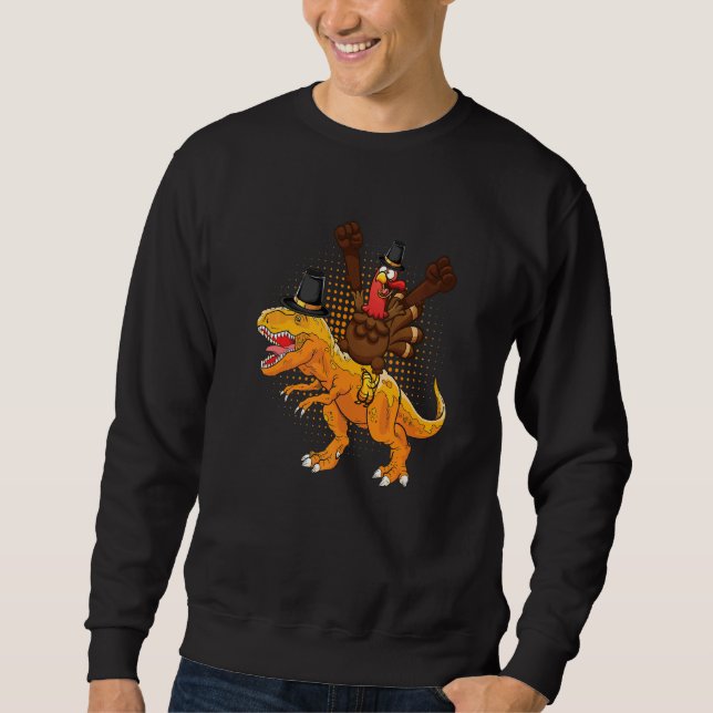 Sudadera A happy turkey riding a dinosaur they wear hat tha (Anverso)