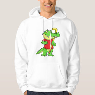Sudadera Cocodrilo en hockey sobre hierba con bastón de hoc