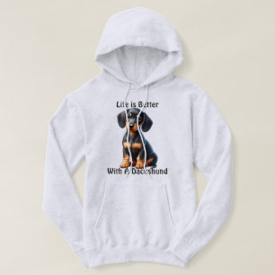 Sudadera Dachshund Puppy Sentado y mirando con indiferencia