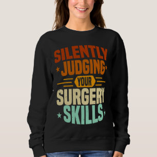 Sudadera Enfermera de Anestesia Juzgando Habilidades de Cir