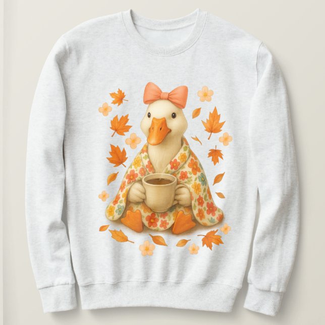 Sudadera Ganso con café y manta, ambiente otoñal acogedor (Anverso del diseño)
