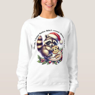 Sudadera Raccoon in a Santa hat disfruta de galletas en los