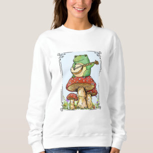 Sudadera Rana Cottagecore con casa de hongos tocando banjo
