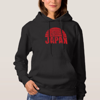 Sudadera Un Japón divertido bajo un fondo rojo de atardecer