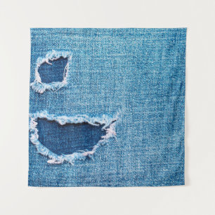 Tapiz Fondo del denim texturado. Agujero desgarrado en l