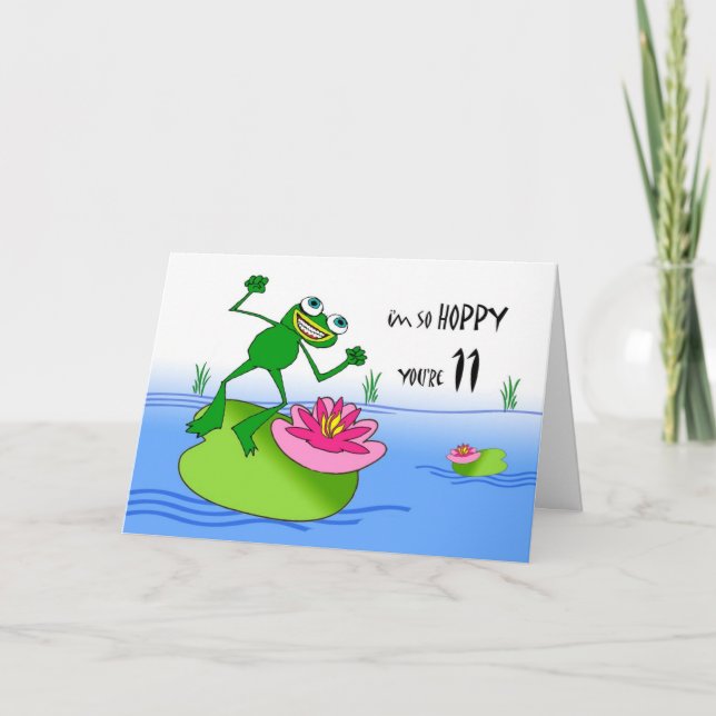 Tarjeta Adorable undécimo cumpleaños, rana divertida en es (Anverso)