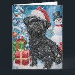 Tarjeta Alegría de los Navidades Affenpinscher Winter Wond<br><div class="desc">Este diseño festivo capta el alegre espíritu de la temporada navideña, con un adorable cachorro vestido con un sombrero de Santa. El perro está enclavado en un maravilloso país invernal, con un muñeco de nieve, un árbol de Navidad decorado y regalos hermosamente envueltos. Los copos de nieve caen suavemente, añadiendo...</div>