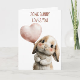 Tarjeta Algun conejo te ama con globo de corazón