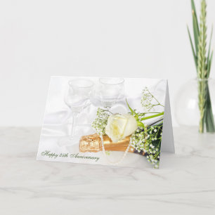 Tarjeta aniversario boda con champán y rosa blanca