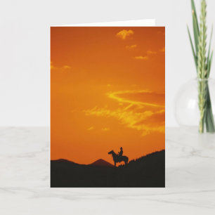 Tarjeta Atardecer naranja con Silhouette Cowboy