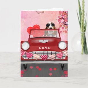 Tarjeta Basset Hound conduciendo un coche con corazones de