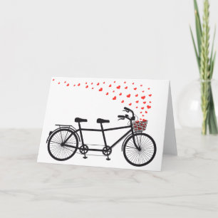 Tarjeta bicicleta tándem con corazones rojos