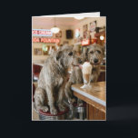 Tarjeta Birthday Irish Wolfhounds Enjoying a Milkshake<br><div class="desc">A pair of Irish Wolfhound dogs sitting on stools share a milkshake in a retro diner.
The inside text can be changed.</div>