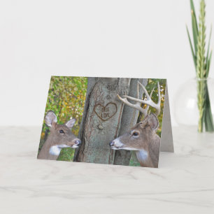 Tarjeta buck and doe with heart on tree