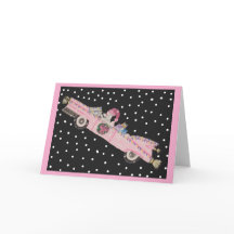 Caniche en Navidad en un convertible rosa