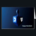 Tarjeta Chanukkah Dreidel<br><div class="desc">Un dreidel modernista,  metálico y azul sobre un fondo oscuro y nocturno. Dos de las letras hebreas encontradas en un dreidel,  una monja y un shin,  brillan brillantemente. El texto que dice "Feliz Hanukkah" también aparece en azul brillante y blanco.</div>