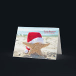 Tarjeta Christmas starfish with Santa hat<br><div class="desc">Starfish wearing red and white fur Santa hat on ocean beach</div>