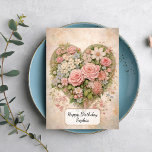Tarjeta Corazón Floral<br><div class="desc">Una delicada ilustración de estilo vintage de un arreglo en forma de corazón lleno de rosas suaves rosadas y flores pastel. La composición está situada sobre un fondo ligero y texturizado con patrones florales sutiles,  creando un diseño romántico y atemporal inspirado en la estética clásica shabby chic.</div>