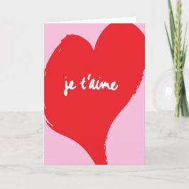 Tarjeta Corazón rojo con texto je t’aime sobre fondo rosa